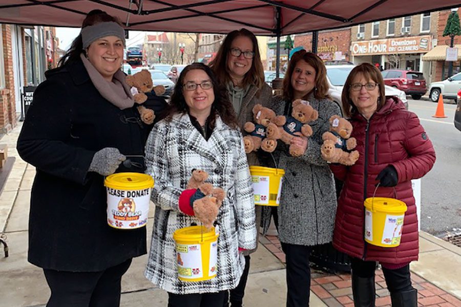 About Our Agency - Portrait Smiling Helwig Insurance Agency Staff Members Standinig in Downtown Indiana Pennsylvania Collecting Donations