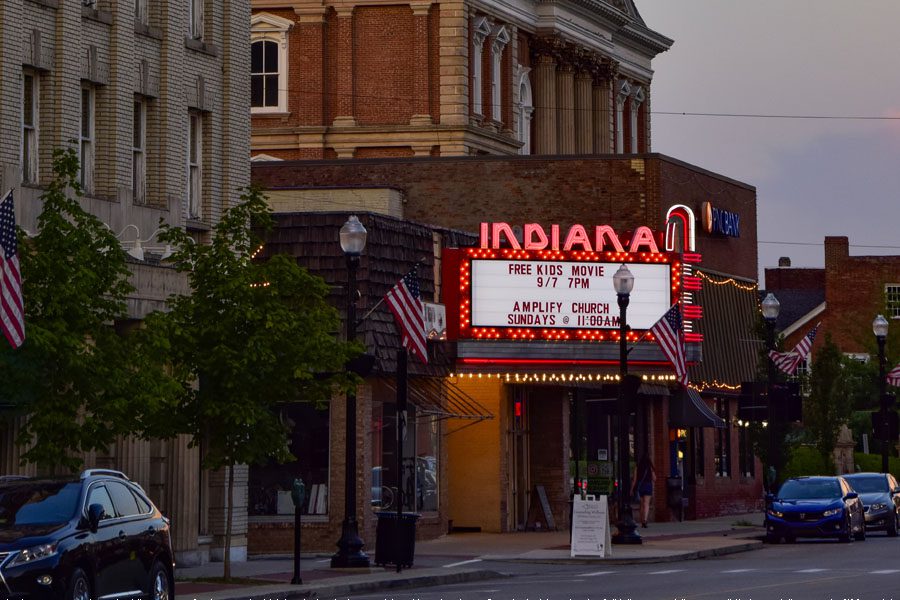Indiana, PA - View of the Indiana Theatre Next to Other Buildinigs in Downtown Indiana Pennsylvania in the Evening with the Lights On